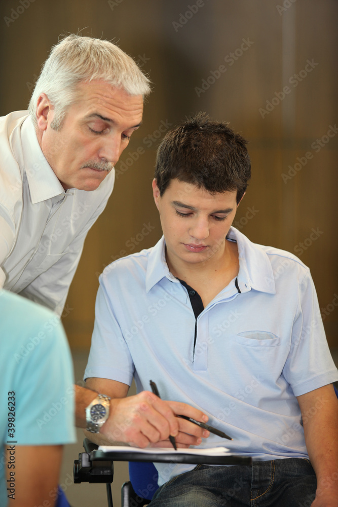 Fototapeta premium Teacher correcting his student's homework