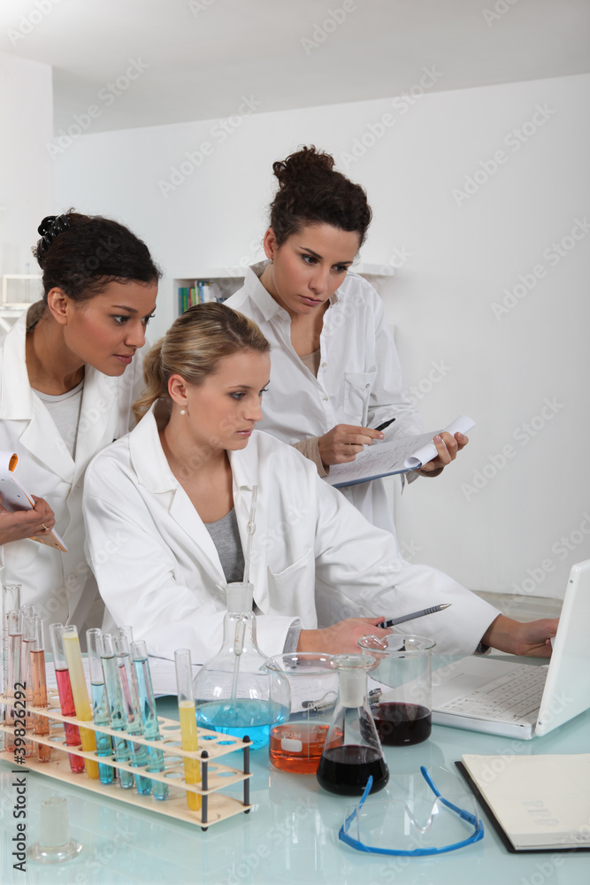 A scientist team examining the results of an experiment A scientist team examining the results of an experiment