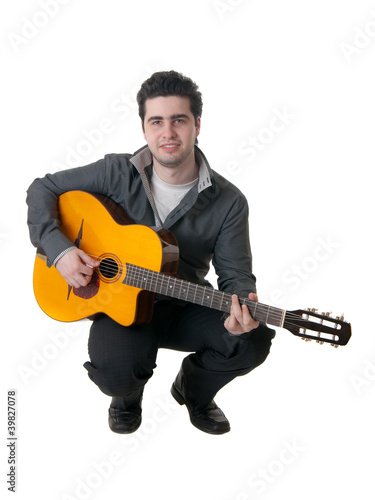 The musician plays an acoustic guitar