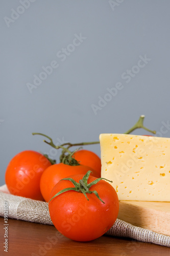 Yellow cheese with tomatoes