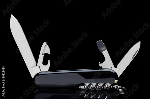 Swiss army knife isolated on black photo