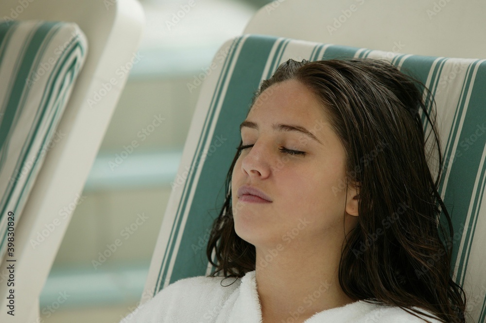 Teenager laying on deck chair