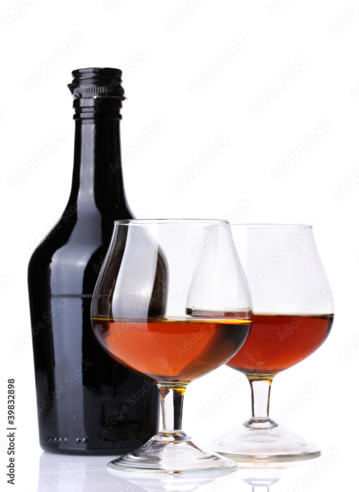 Glasses of brandy and bottle isolated on white Glasses of brandy and bottle isolated on white