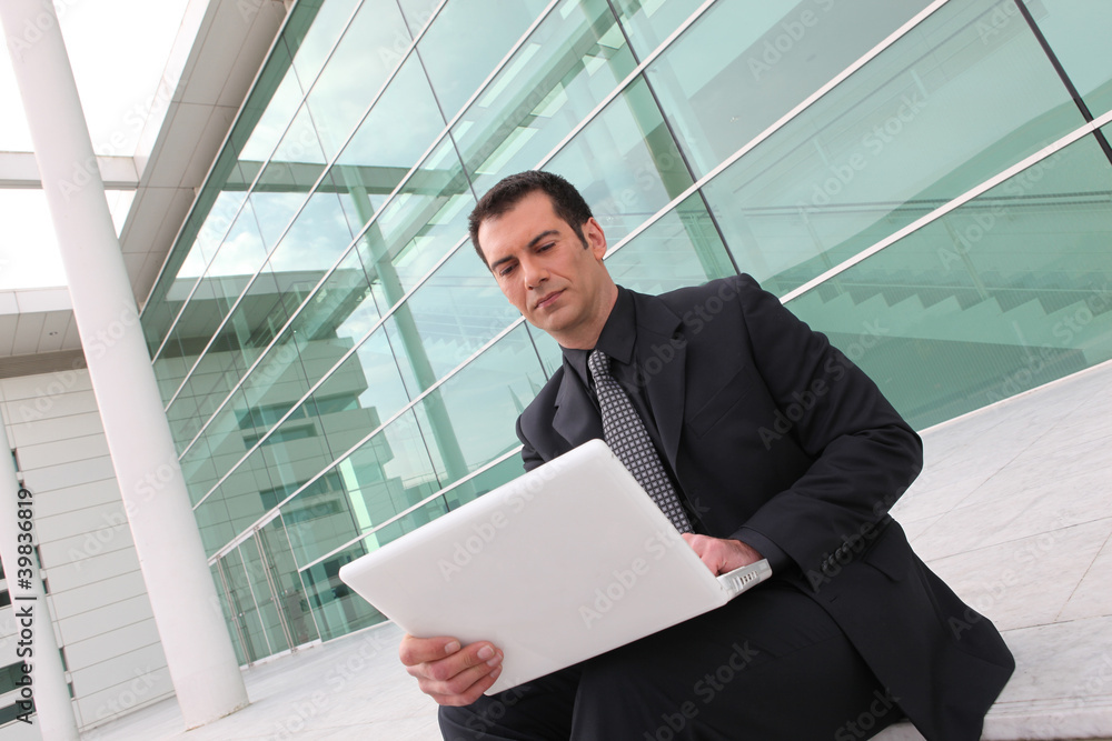 Worker connecting with laptop outdoors Worker connecting with laptop outdoors