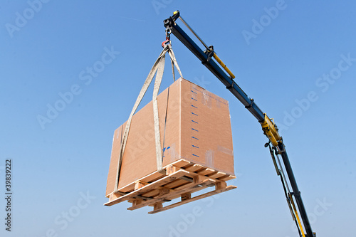 Crane elevating a box