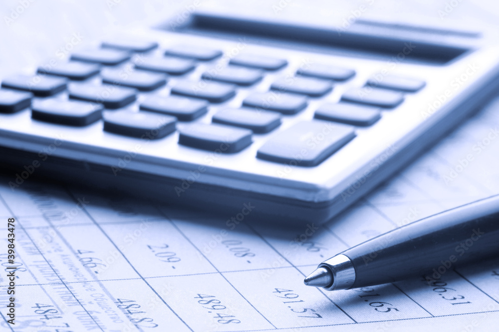 pen and calculator on business paper pen and calculator on business paper