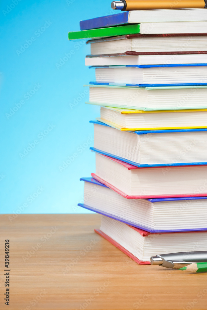 pile of books and pens pile of books and pens