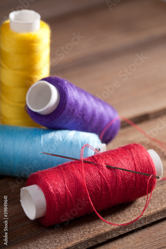 coloured bobbins of thread