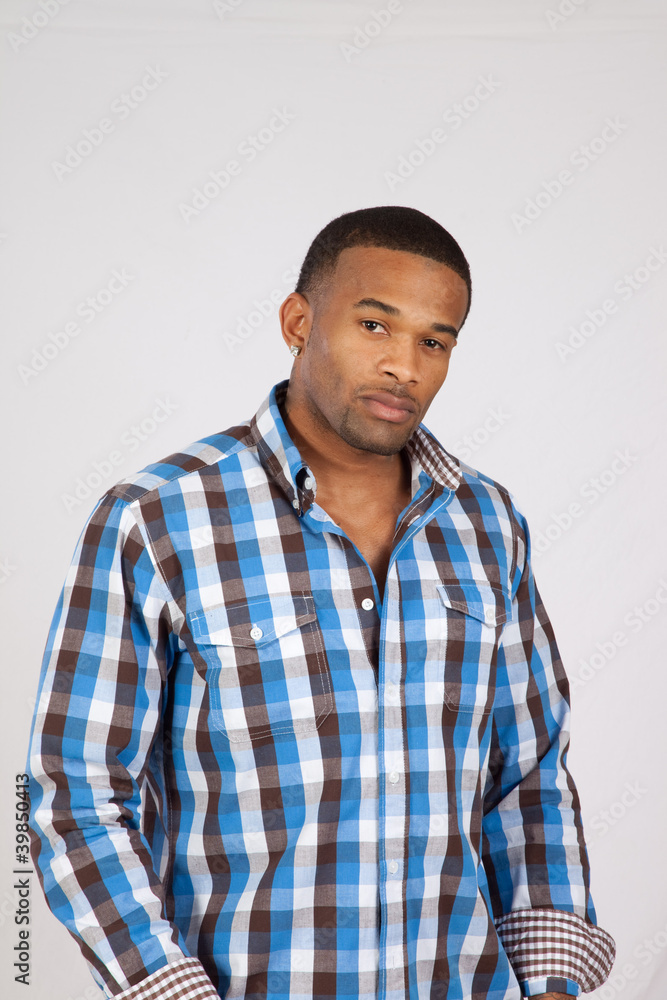 black man in plaid shirt looking at camera black man in plaid shirt looking at camera