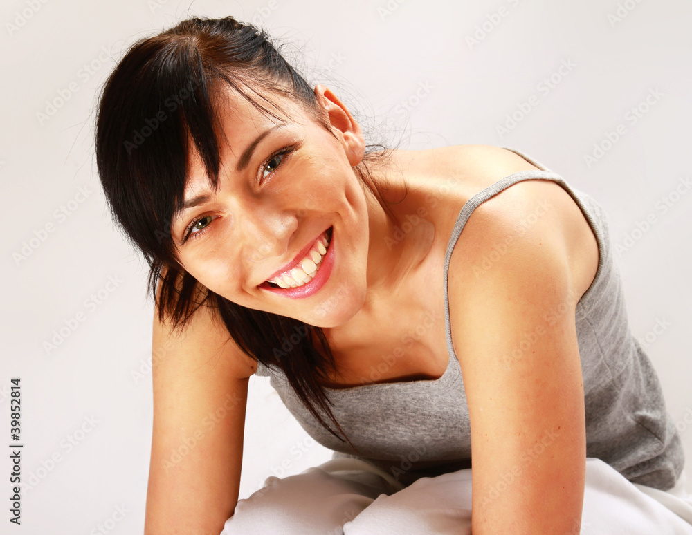 A pretty young woman sitting on the floor A pretty young woman sitting on the floor