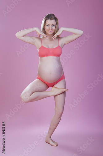 pregnant woman is engaged in gymnastics