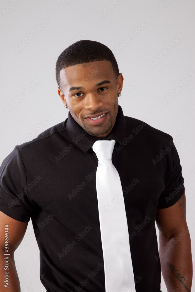 black man in black shirt and white tie, smiling at camera Stock Photo |  Adobe Stock