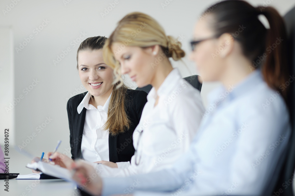 business woman standing with her staff in background business woman standing with her staff in background