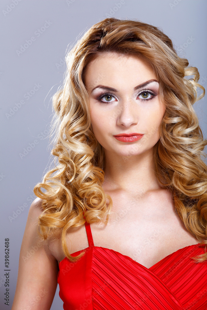 Young woman in red dress with curly hair Young woman in red dress with curly hair