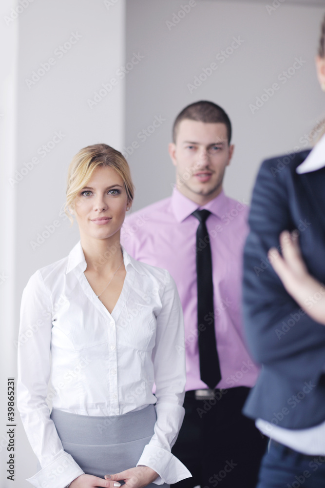 business woman standing with her staff in background business woman standing with her staff in background