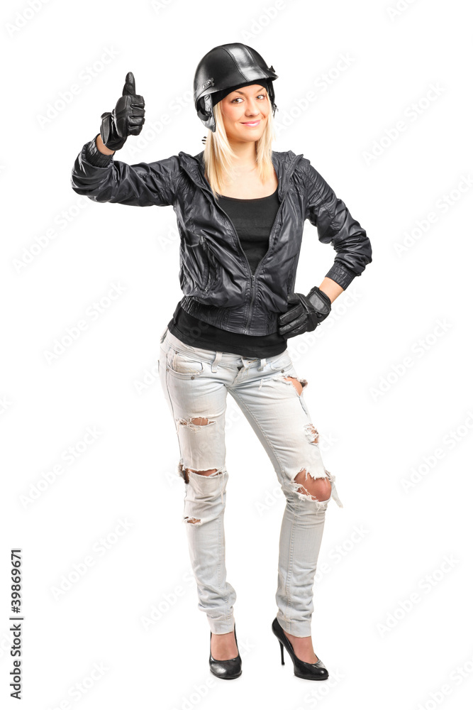 Full length portrait of a smiling female motorcycler giving a th Full length portrait of a smiling female motorcycler giving a th