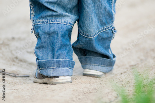 Closeup on a kids feet wearing grey sandals