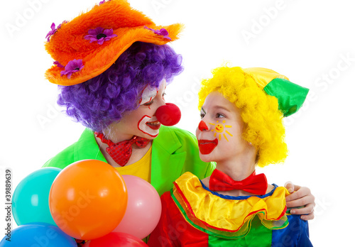 two children dressed as colorful funny clown with balloons