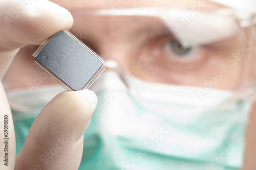 Scientist examining a microchip