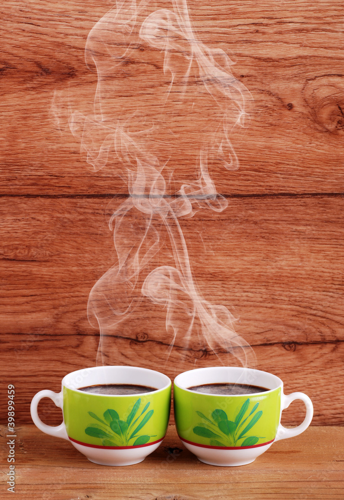 Foto Stock due tazze di caffè fumante | Adobe Stock