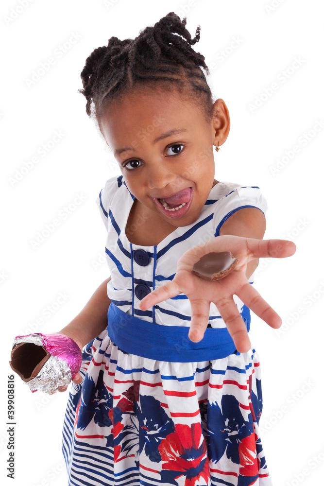 Obraz premium Little african american girl eating chocolate easter egg