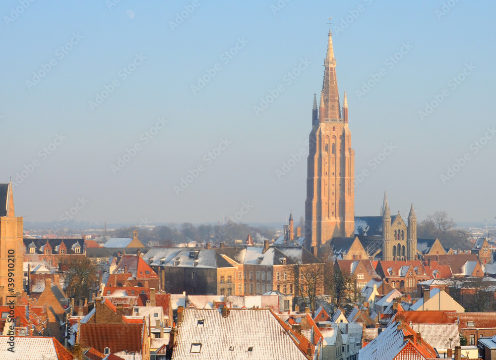 Naklejka premium Church of Our Lady and roofs in winter in Bruges