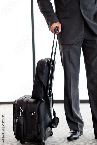 businessman with luggage at airport