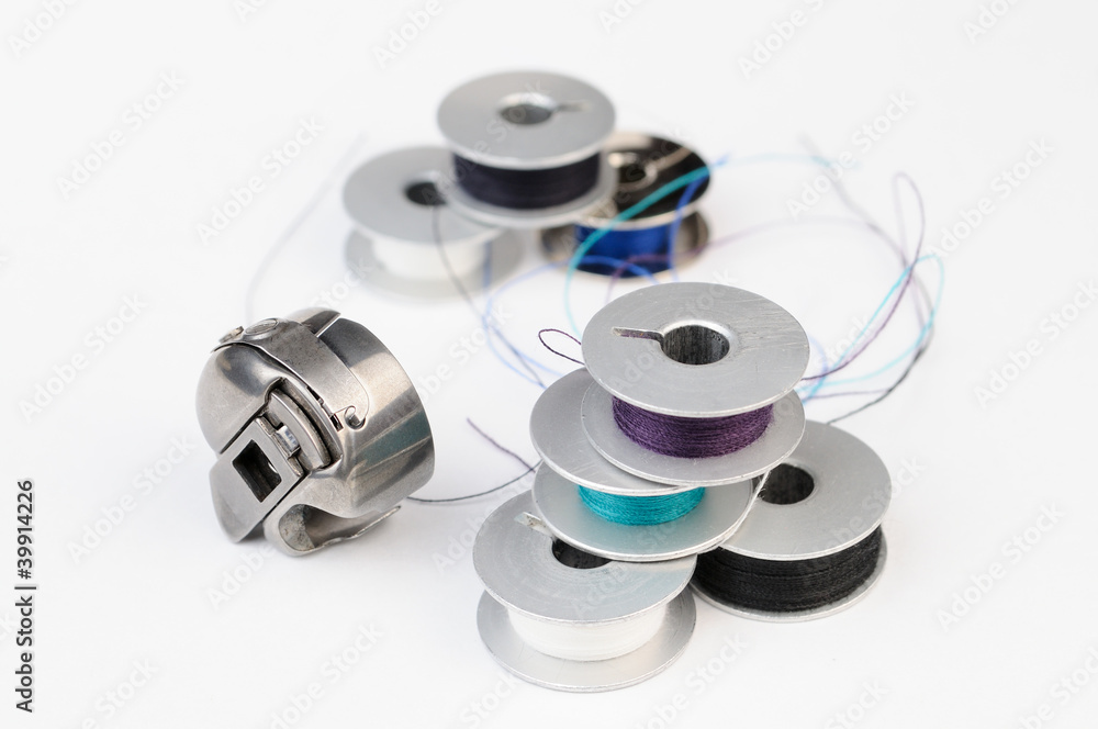 Tailor tools: Metal bobbins of thread and sewing machine shuttle Tailor tools: Metal bobbins of thread and sewing machine shuttle