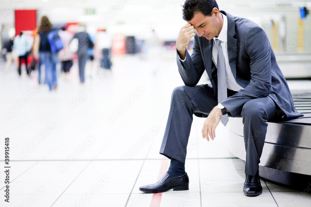 worried businessman lost his luggage at airport - obrazy, fototapety, plakaty 