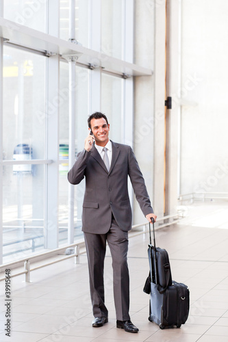 businessman talking on mobile phone at airport