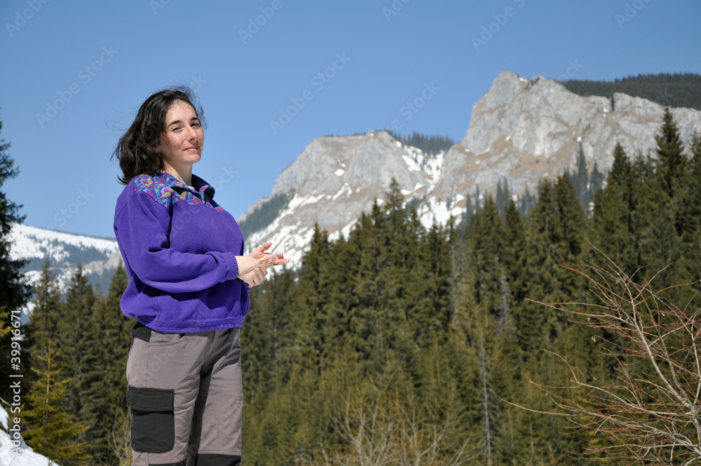 Portrait of a young woman at winter in the mountains
