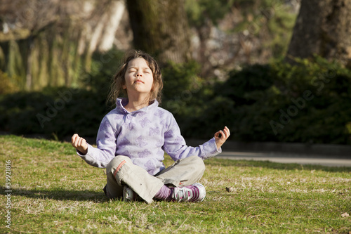 child in full meditation in the midst of a lawn
