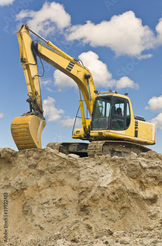 Caterpillar excavator on sand hill