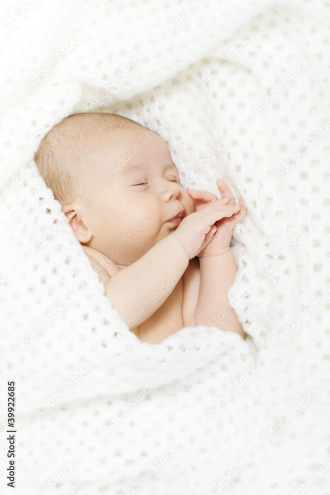 Sleeping newborn baby covered with white blanket Sleeping newborn baby covered with white blanket