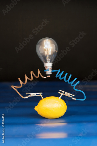 lemon and lamp on black background