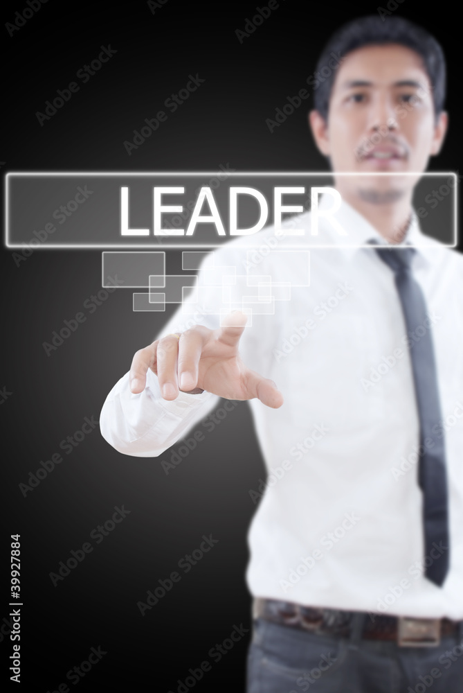 Businessman pushing Leader word on a touch screen interface. Businessman pushing Leader word on a touch screen interface.