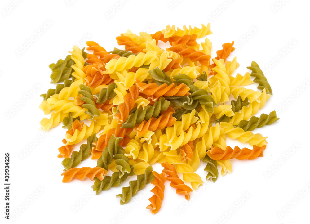 Uncooked pasta fusilli in different colours, white background Uncooked pasta fusilli in different colours, white background
