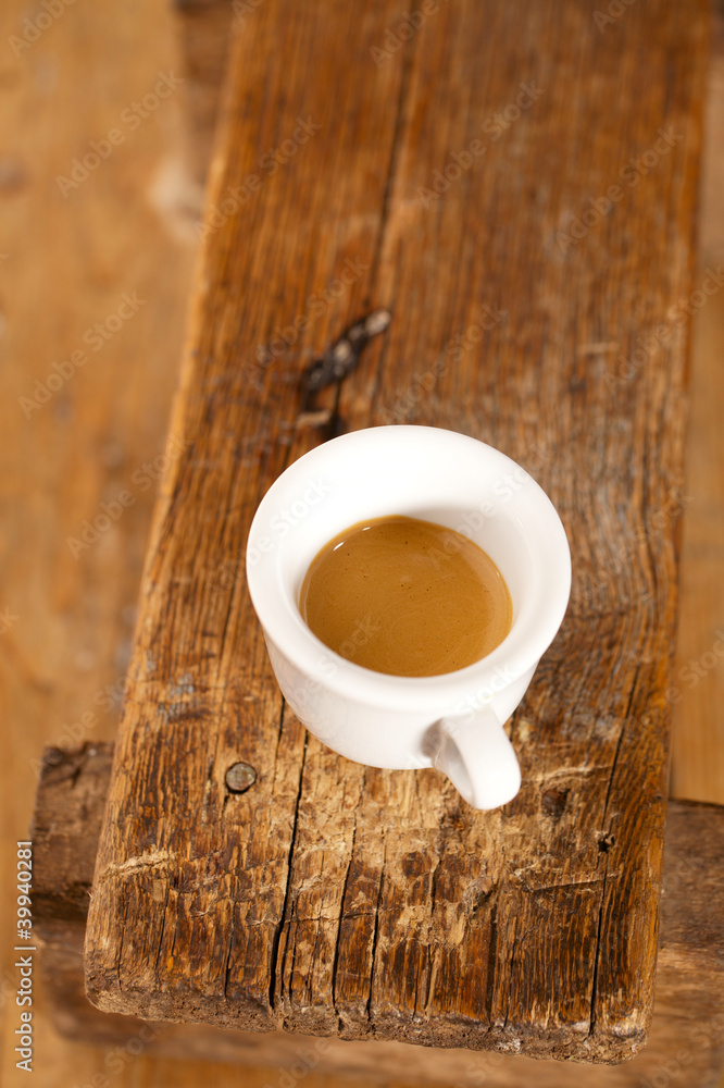 Obraz premium espresso coffee in thick white cup on old wooden bench