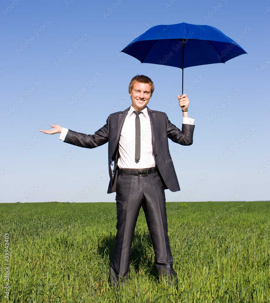 Image of young businessman with blue umbrella Image of young businessman with blue umbrella