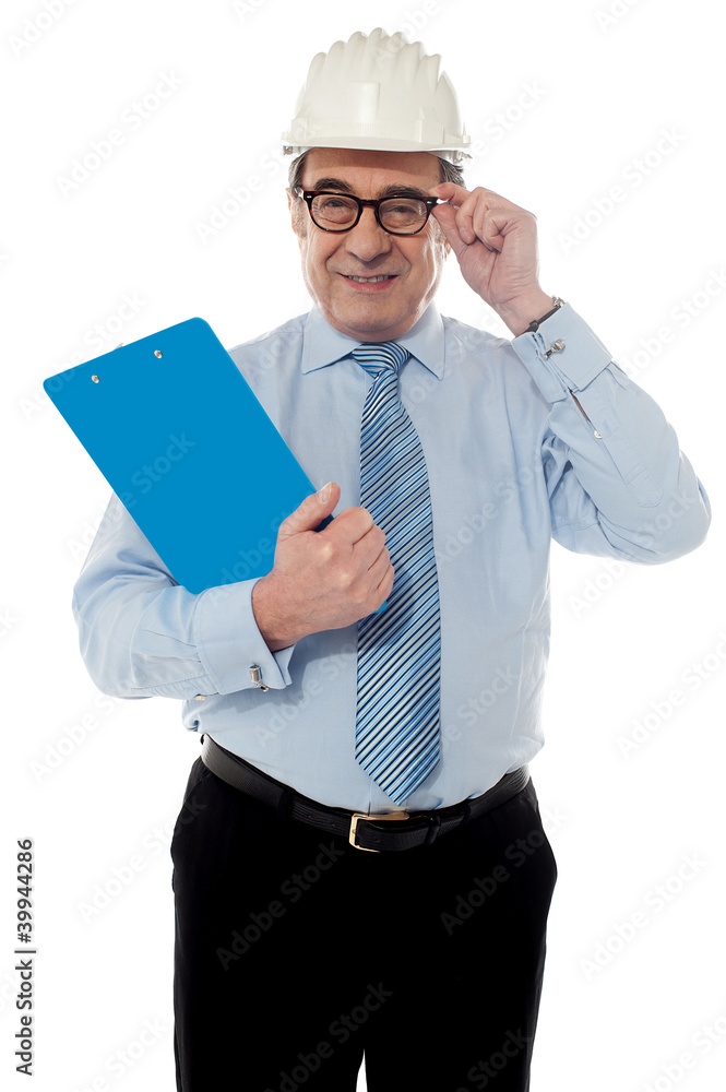 Smiling matured architect holding his eye-wear Smiling matured architect holding his eye-wear