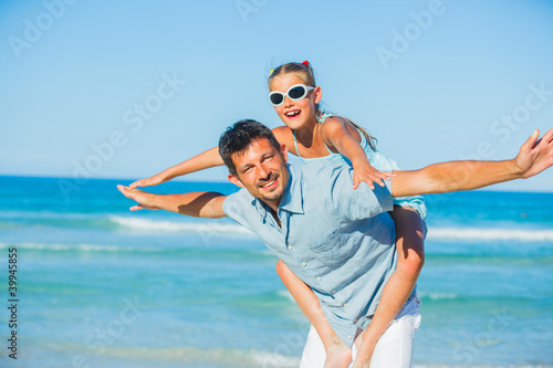 Father and his daughter having fun on beach