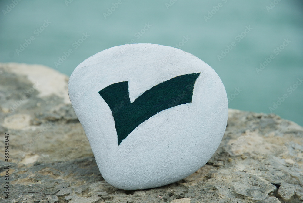 check mark symbol painted on a stone check mark symbol painted on a stone