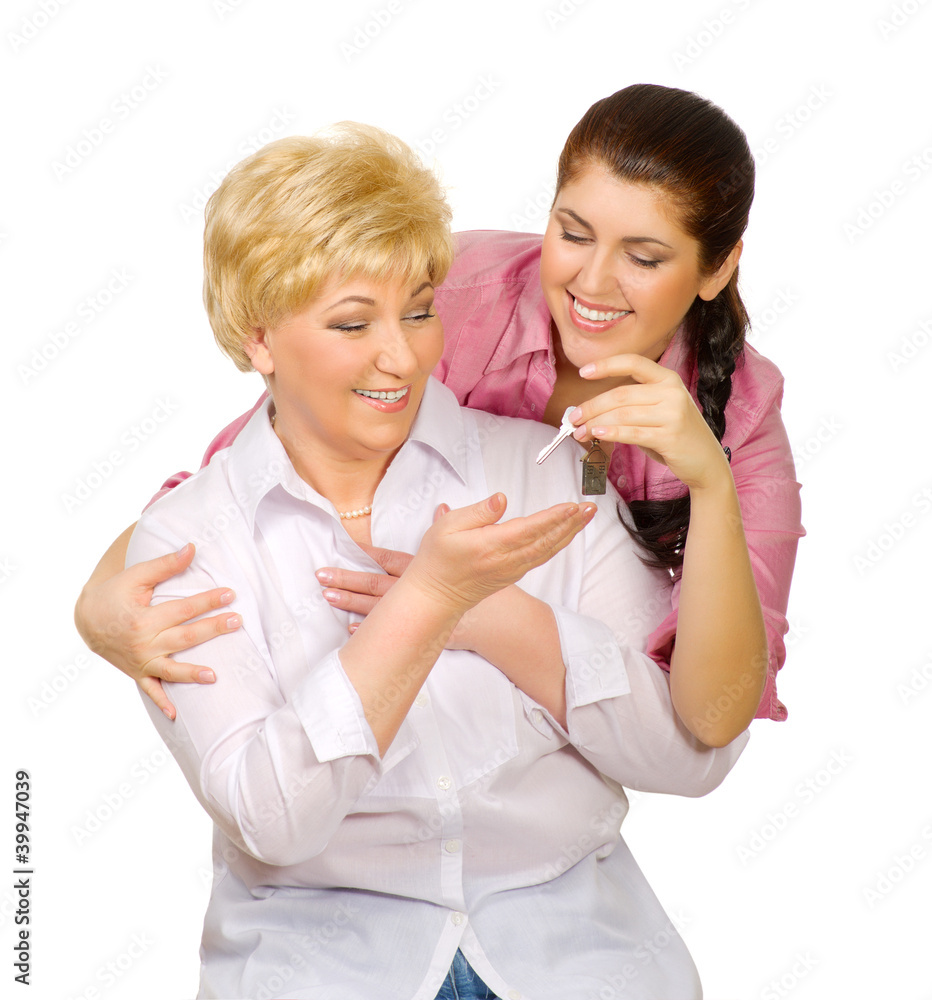 Young woman give keys to her mother Young woman give keys to her mother