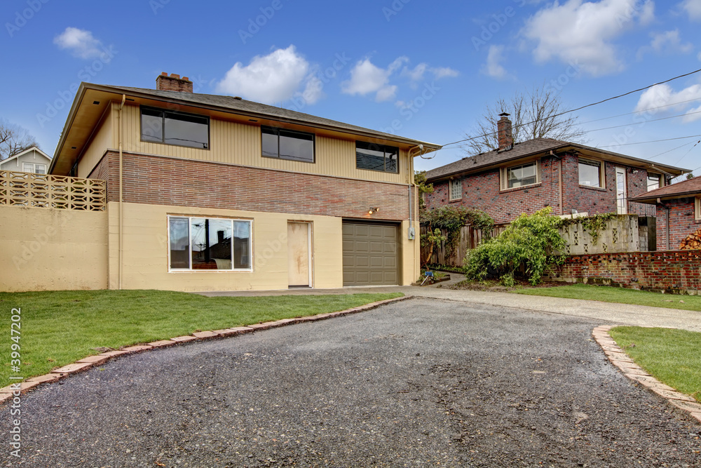 House exterior Backyard with driveway and garage. House exterior Backyard with driveway and garage.
