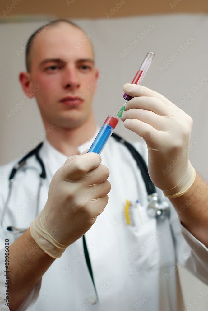 young male doctor holding vaccine in his hand
