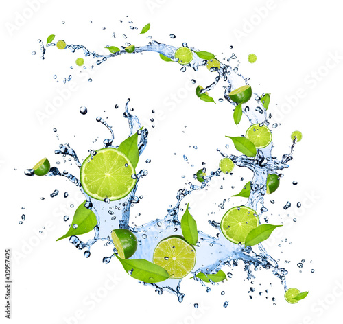 Limes pieces falling in water splash on white background