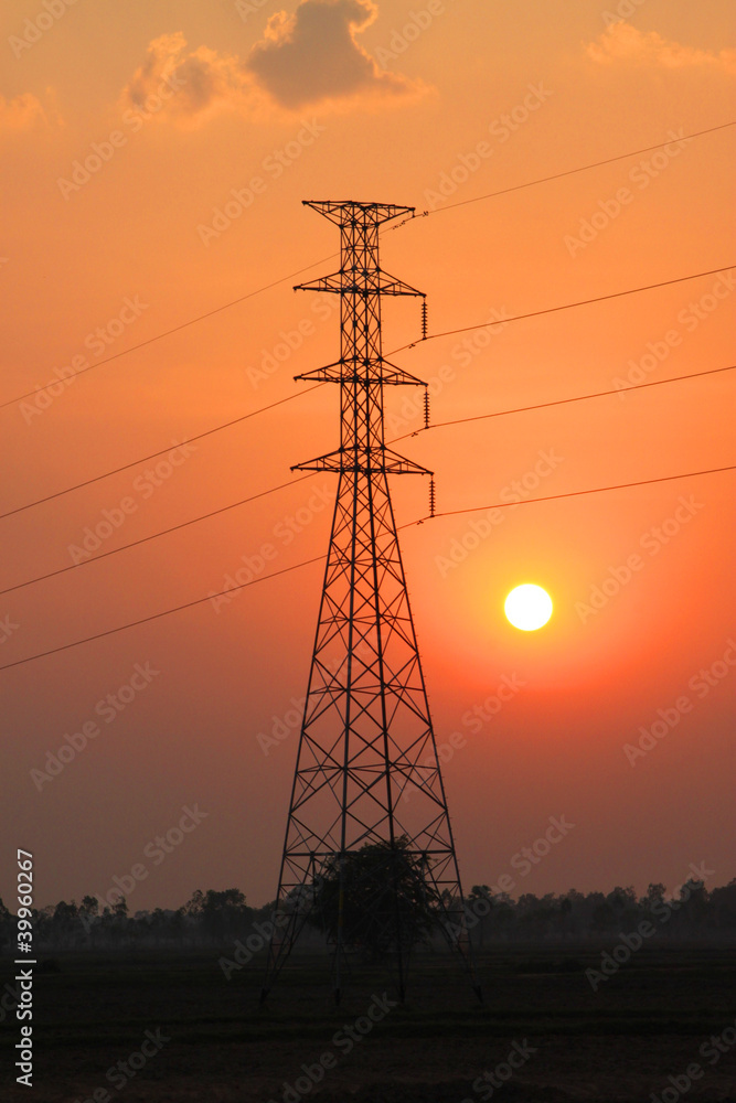 High voltage pole tower and sunset