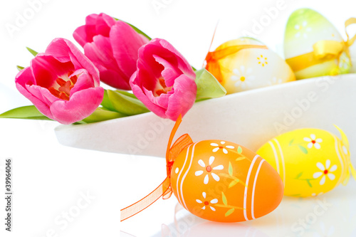 tulips and easter eggs on white photo