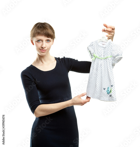 Young mother choosing dress for daughter