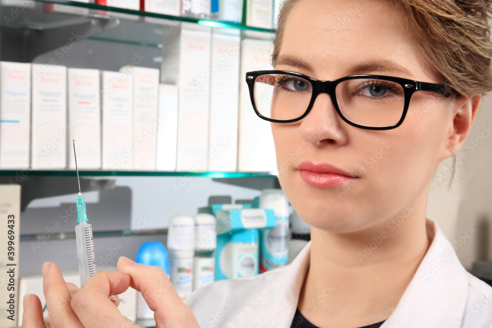 young pharmacist holding an injection young pharmacist holding an injection